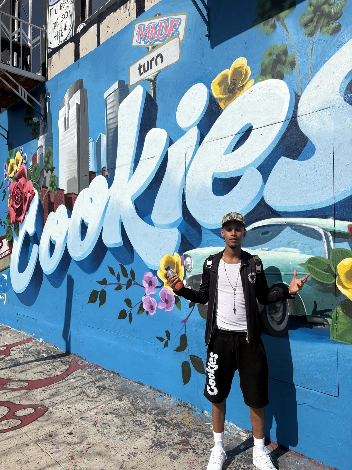 Dash in front of the Cookies mural in L.A.